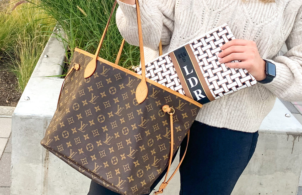 A personalized Laura Weave Bag coming out of a Louis Vuitton Tote.